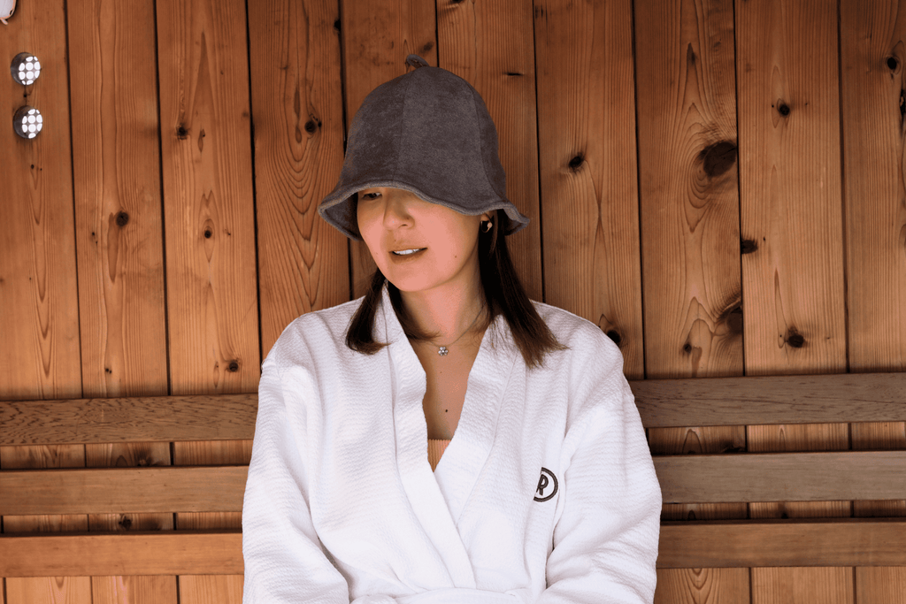 Women in sauna hat with slate grey color looking to the left